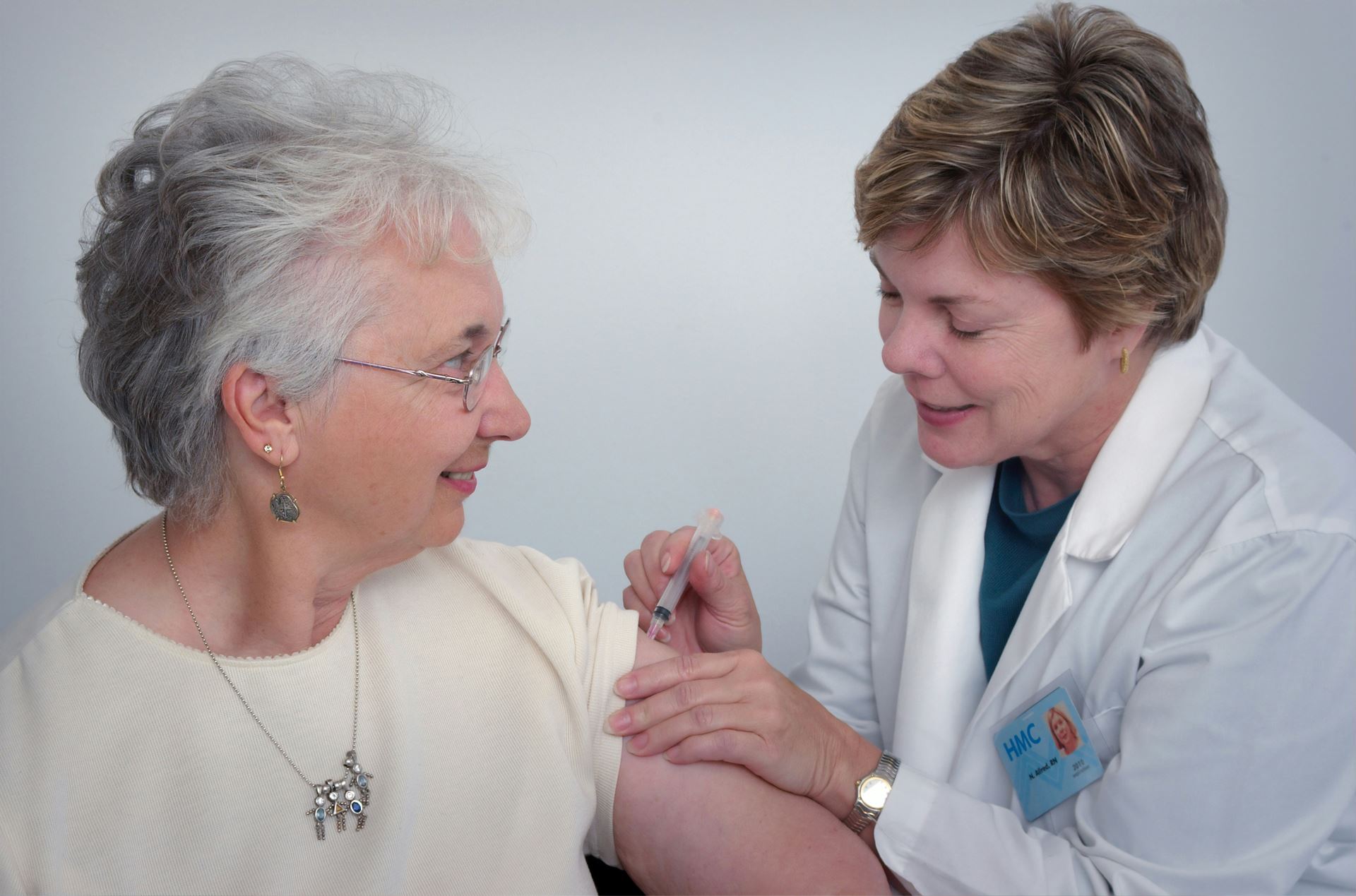 Lady having vaccine into arm