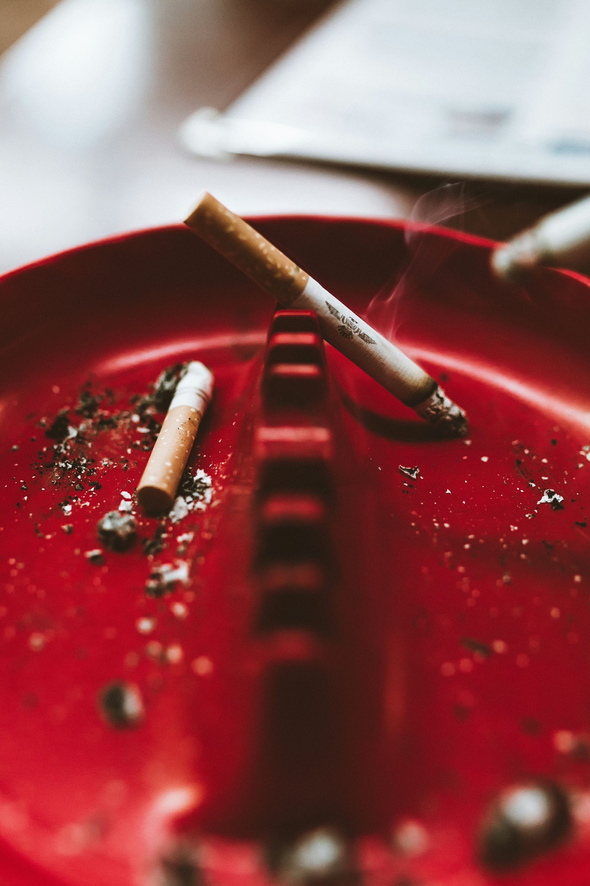 Cigarettes in a red ashtray