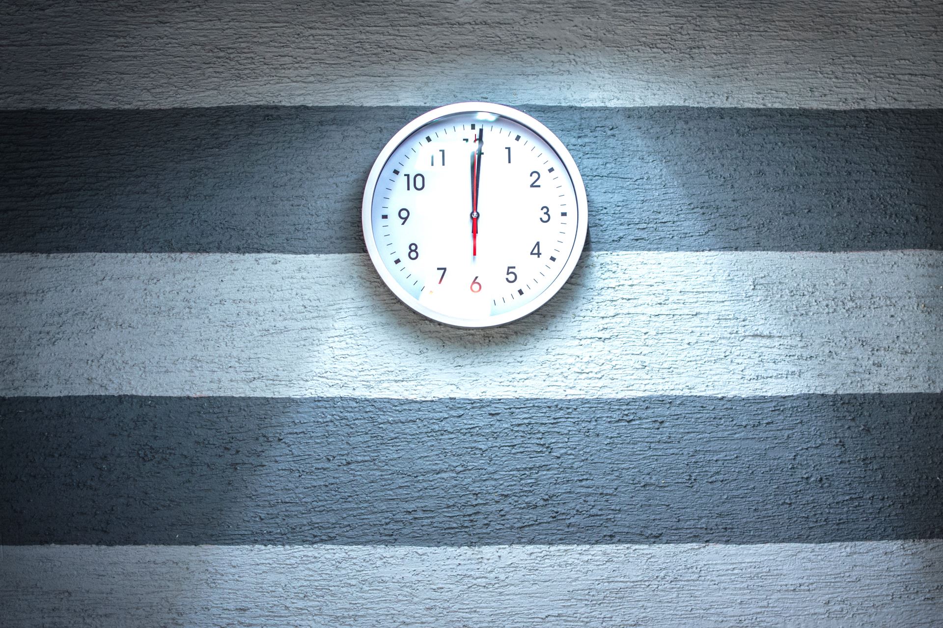 a clock hanging from the side of a building